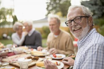 Smiling senior man enjoying garden party