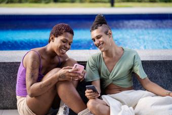 Portrait of transgender friends using smart phone