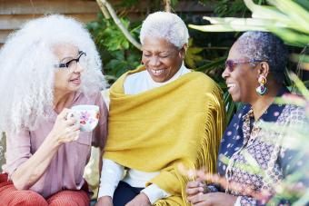 Three senior women talking in garden