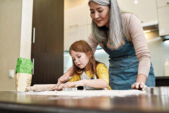 Senior and granddaughter baking cookies