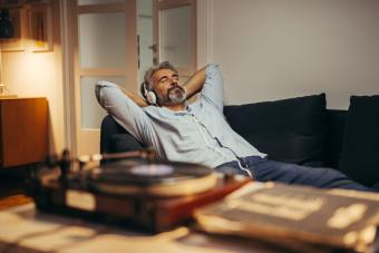 Middle aged man listening to music in his couch