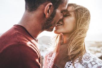 Romantic couple kissing at sunset