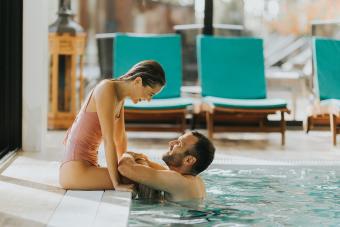 Handsome young couple relaxing in the indoor swimming pool